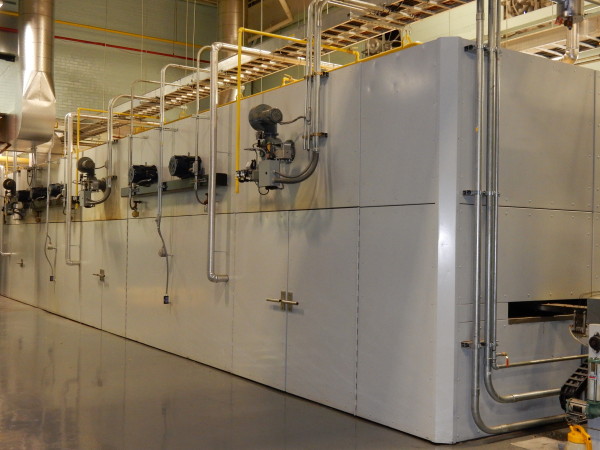 A small green and yellow cargo truck with an open back.