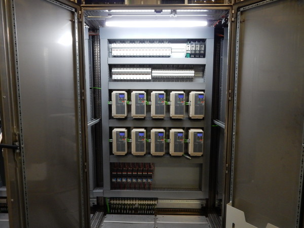 A small green and yellow cargo truck with an open back.