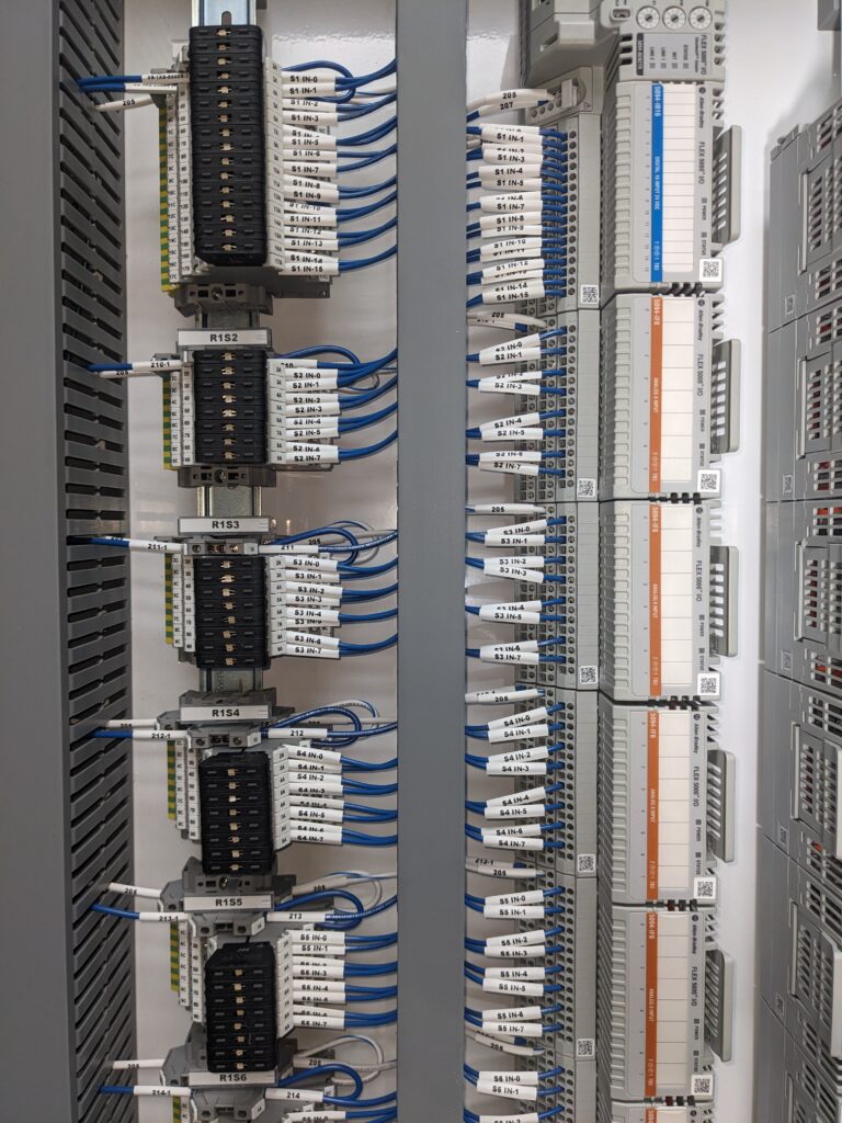 A small green and yellow cargo truck with an open back.